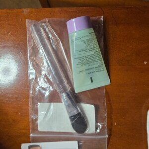 Clinique face scrub and makeup brush